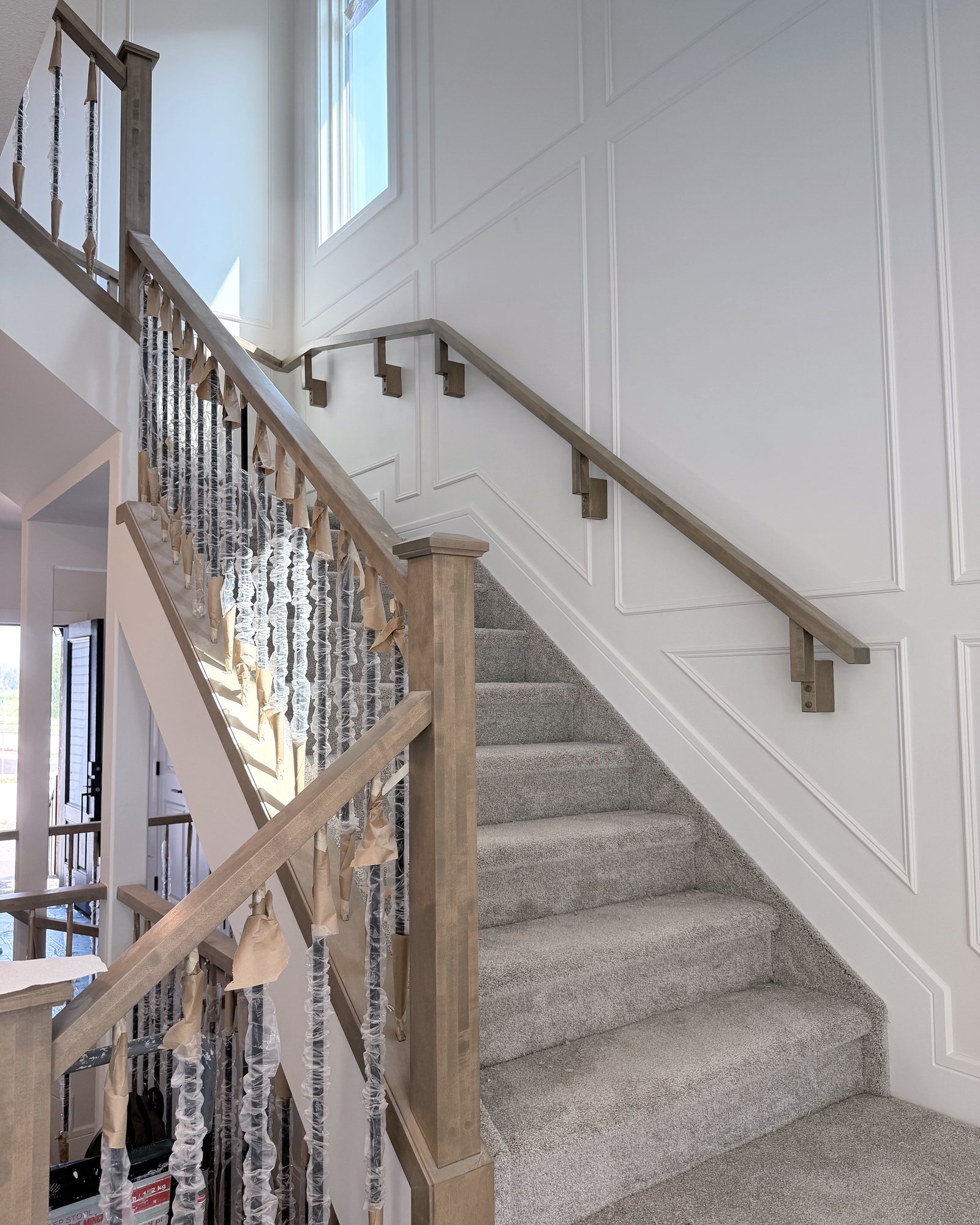 New staircase with spindles still wrapped in protective film